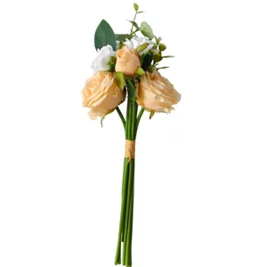Detailed macro view of champagne artificial roses and white camellia wedding bouquet