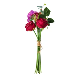 Detailed macro shot of realistic artificial rose and camellia hand-tied bridal bouquet
