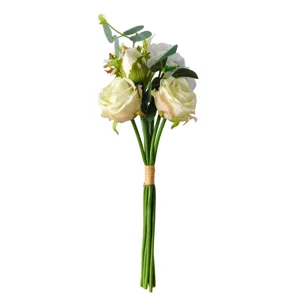 Detailed view of hand-tied cream rose and camellia bouquet with natural green stems