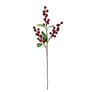 Detailed view of artificial red berry branch with green leaves for home decor