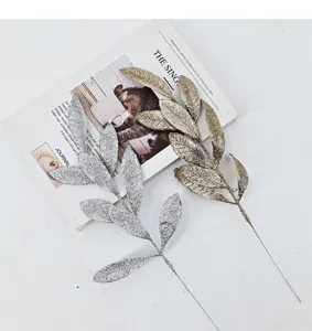 Detailed macro view of gold and silver glitter artificial leaves for Christmas decoration