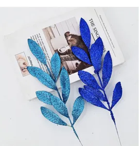 Close-up of blue and cyan glitter artificial leaf branches for Christmas DIY decor
