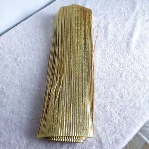 Detailed view of shimmering gold holographic laser grass for festive decorations.
