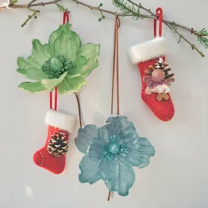 Vista dettagliata di fiori artificiali di Natale e calze sospese per decorazioni natalizie.