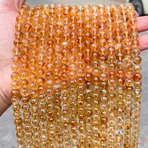 Close-up of 8mm natural yellow citrine round beads with transparent texture.