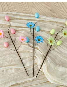 Close-up of decorative Easter picks featuring spotted foam eggs and colorful daisy flowers