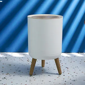 Minimalist Japanese-style white round trash can featuring elevated wooden legs and lid