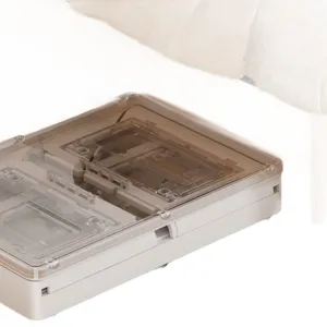 Detailed view of a portable foldable storage box with wheels tucked under a bed or sofa