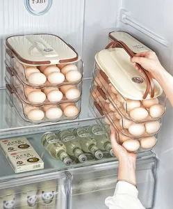 Hand lifting a multi-layer transparent egg storage box showing handle and stackable design