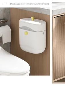 White wall-mounted bathroom trash can with yellow tab lid shown in toilet setting