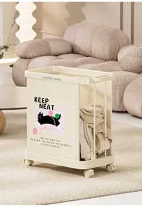 Detail view of cream-style rolling laundry hamper with cute cat graphic and wheels