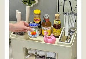 Detailed view of cream kitchen organizer rack holding various spice jars and utensils