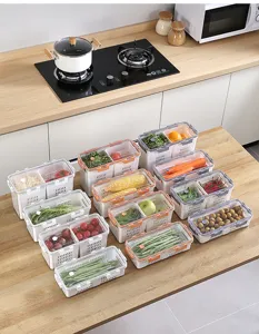 Detailed view of stackable food storage containers with drainage baskets in kitchen.