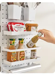 Wall-mounted kitchen pegboard organizer with multi-level storage shelves for spices and jars