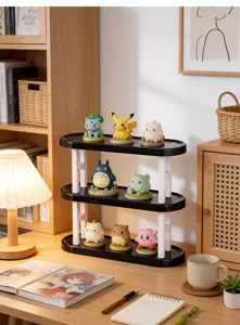 Detail view of a 3-tier black and white desktop display rack organizing mini figurines.