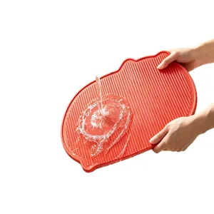 Non-slip red TPU cutting board with ridged surface for easy cleaning and drainage.