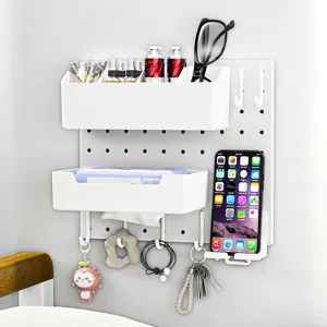Minimalist white wall-mounted pegboard organizer for dorm storage with bins and hooks