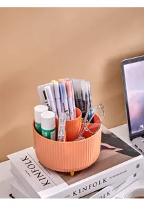 Rotating desktop organizer shown with stationery on Kinfolk books in a warm setup