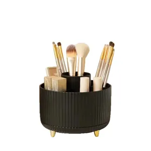 Elegant black rotating makeup brush organizer with ribbed design and gold-toned feet