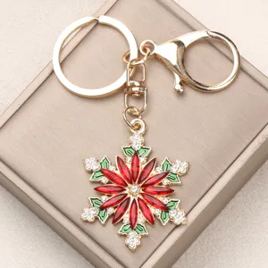 Detailed close-up of a sparkling gold alloy rhinestone snowflake flower keychain