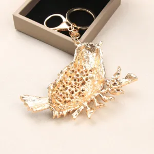 Vintage gold-toned magpie bird keychain, large alloy bag charm with textured finish