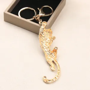 Detailed close-up of a golden vintage leopard keychain made of textured alloy metal