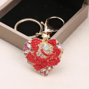Luxurious heart-shaped rose keychain with red beads and crystals shown in a gift box
