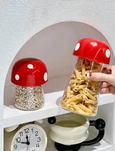 Close-up of red mushroom-shaped kitchen storage jars filled with pasta and grains