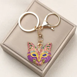 Detailed close-up of a colorful vintage fox mask keychain with sparkly rhinestones
