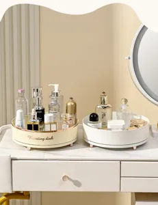 Detailed close-up of rotating skincare organizer trays placed on a white vanity desk