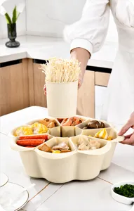 Detail view of rotating multi-compartment drainage basket filled with hot pot ingredients