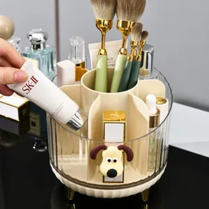 Detail view of a clear rotating cosmetic organizer with a cute dog decor and brushes.