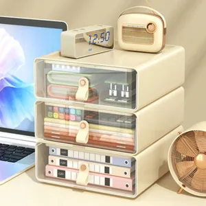 Three-tier cream desktop storage drawers with transparent panels in a workspace