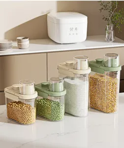 Airtight kitchen storage containers for grains and rice on a white marble counter.