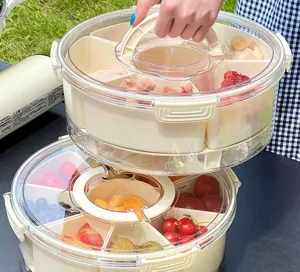 Detail view of stackable portable food containers with segmented inserts for picnic