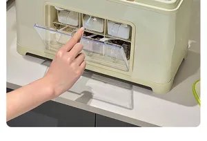 Close-up of hand opening the transparent flip lid of a cream kitchen seasoning box