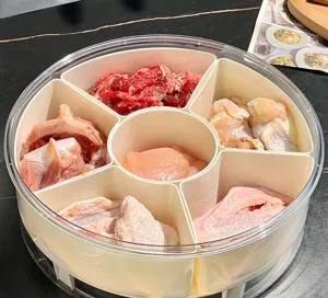 Detailed view of 7-compartment divided food storage container with raw meat preparation