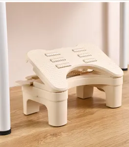 Detail view of the cream ergonomic office footrest with built-in massage rollers.