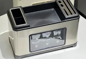 Macro view of stainless steel kitchen organizer with knife slots and spice drawers