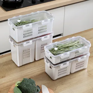 Set of 4 stackable refrigerator storage boxes with drainage holes and clear lids in kitchen.
