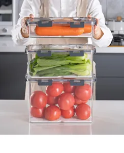 Stackable clear plastic food storage containers with grey locking lids and drain trays