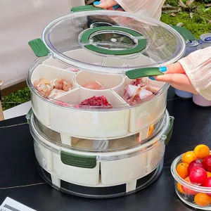 Portable two-tier divided food storage container for outdoor camping and picnic use.
