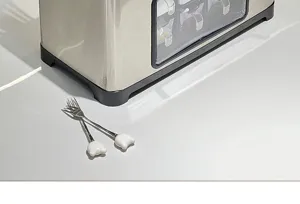 Close-up detail of a stainless steel kitchen storage rack on a clean white surface