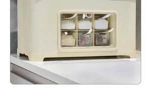 Close-up of seasoning storage box with 6 transparent compartments and small spoons.