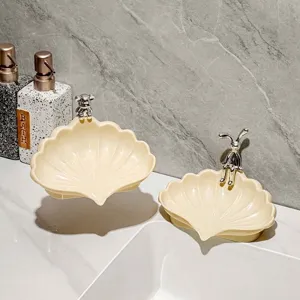 Creative cream shell-shaped soap dish with cute metallic animal accents for bathroom decor