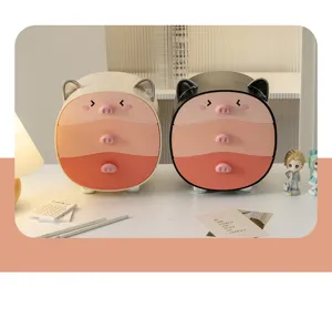 Close-up of cute pig-shaped desktop storage drawers in white and black colors