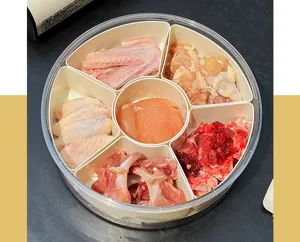Multi-compartment clear kitchen storage container with fresh meat for organization.