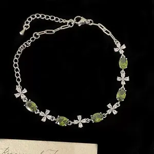 Bracelet élégant en argent avec des zircons vert olive ovales et motifs floraux blancs