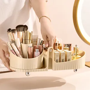Elegant cream rotating makeup organizer filled with brushes and lipsticks on a vanity table.