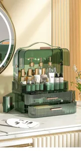 Close-up of luxury green transparent makeup organizer with golden handle and dustproof lid.